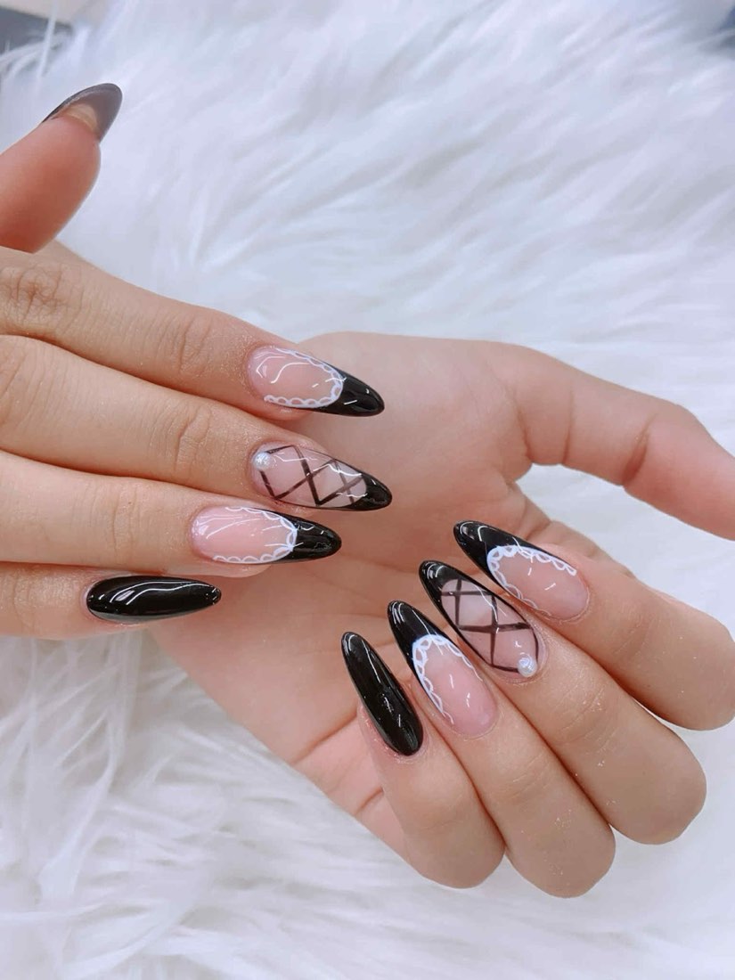 Almond nails with black lace and fishnet french design over glossy black tips