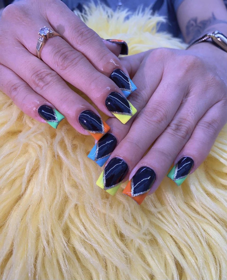 Long square nails in black with neon rainbow french tips