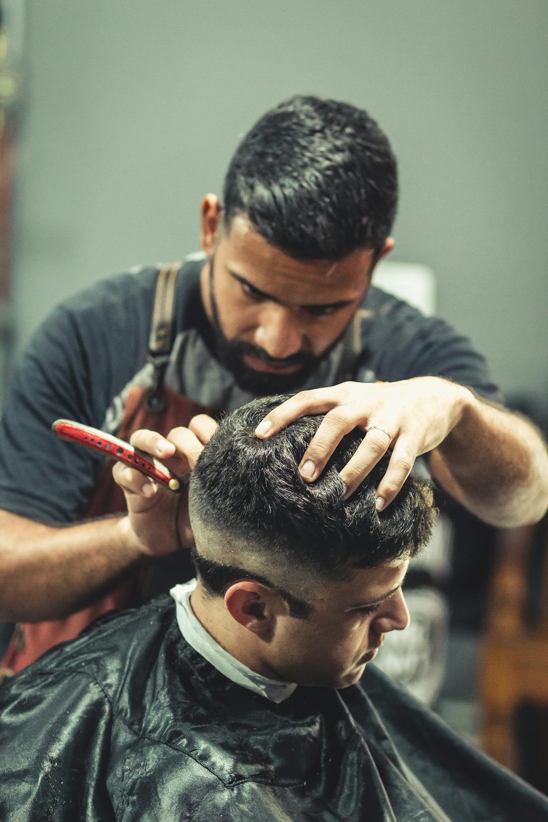 Barber detailing a textured cut