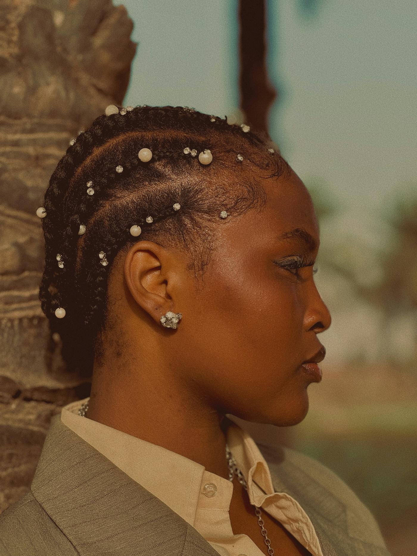 Cornrows accented with pearl beads, side profile