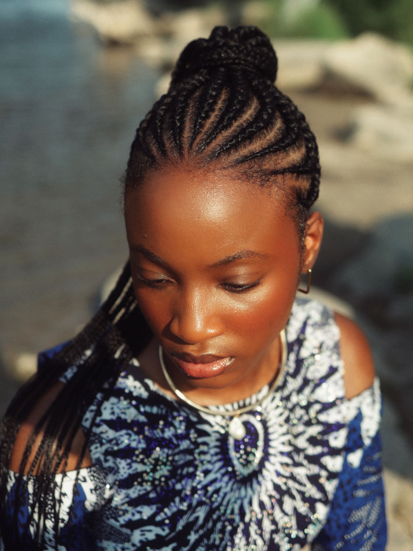 Feed-in braids gathered into a sleek bun