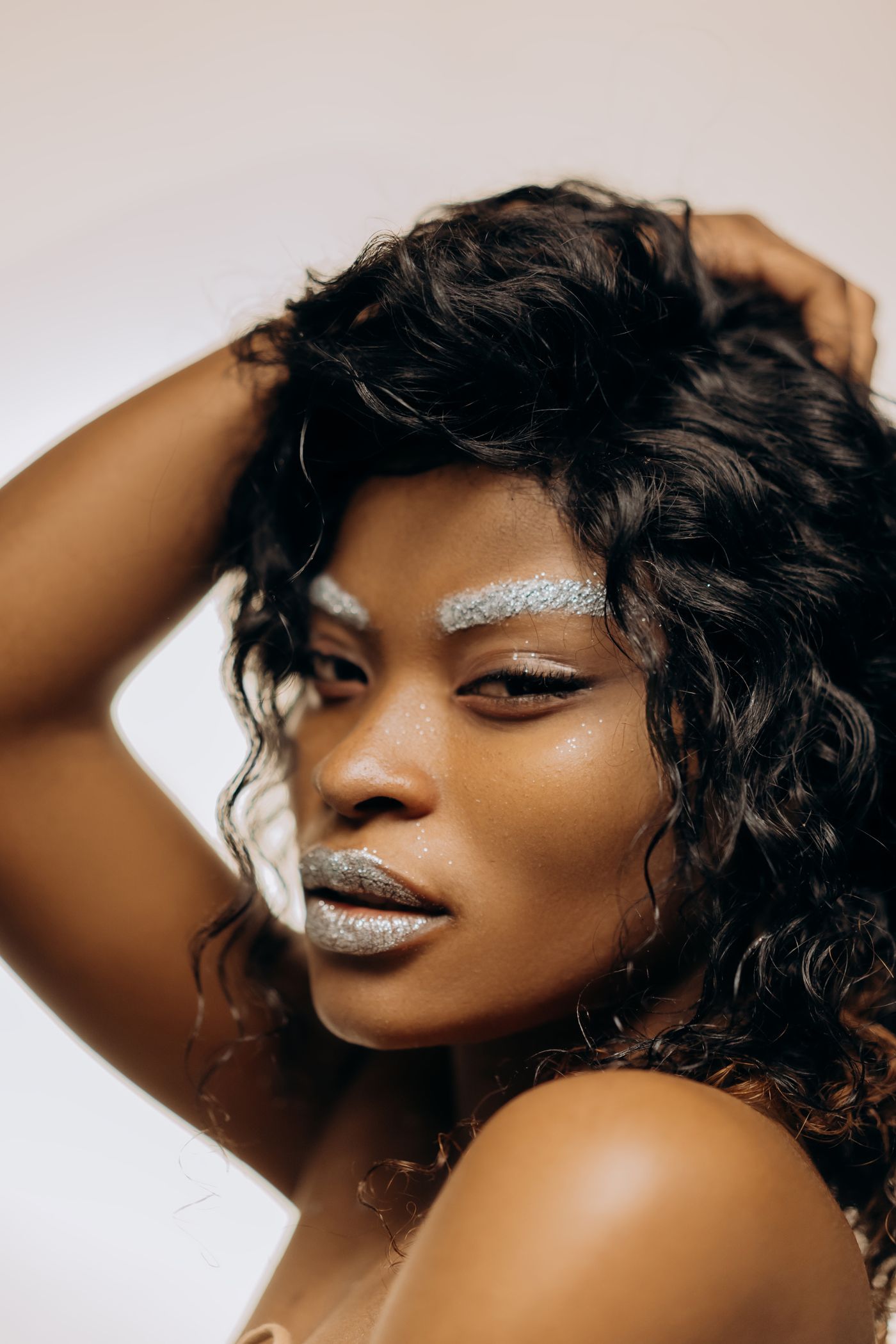 A glowing glam look with luminous skin, soft styling