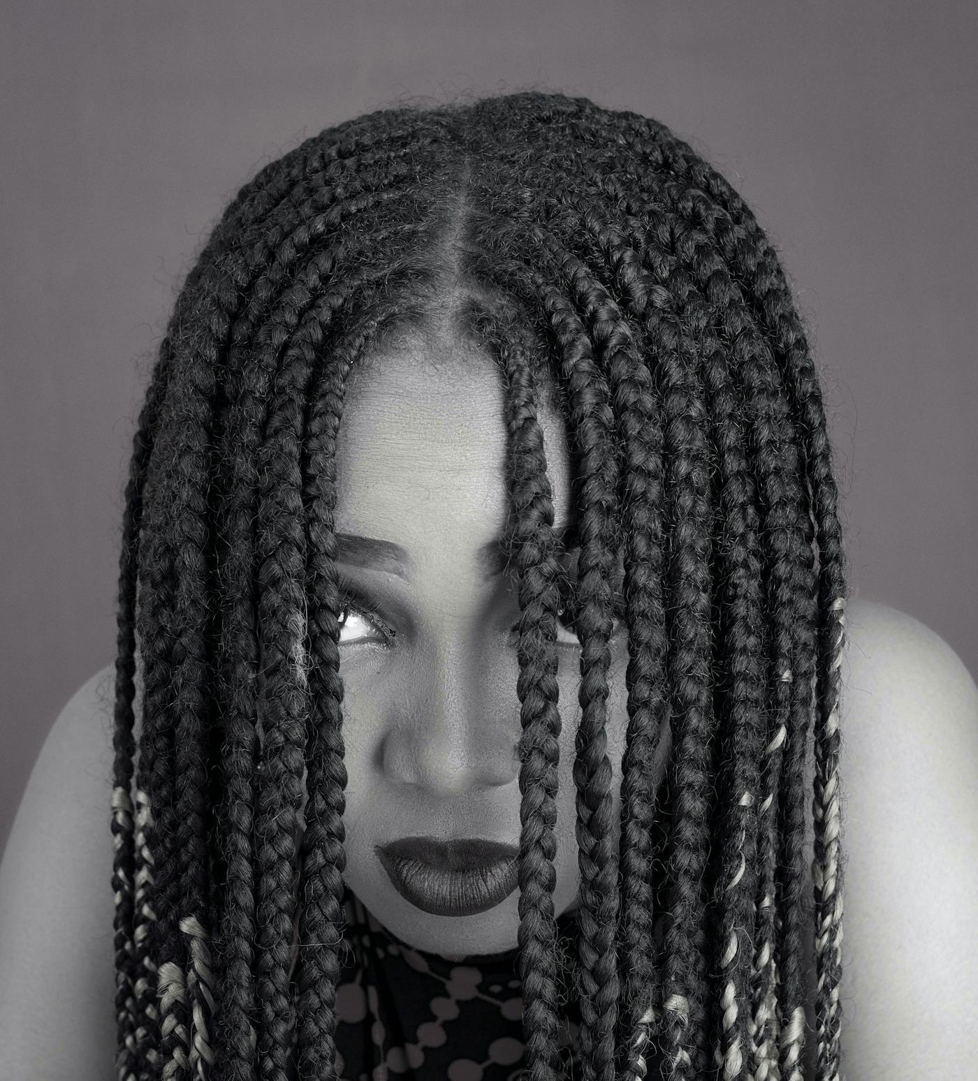 Box braids parted neatly and worn forward