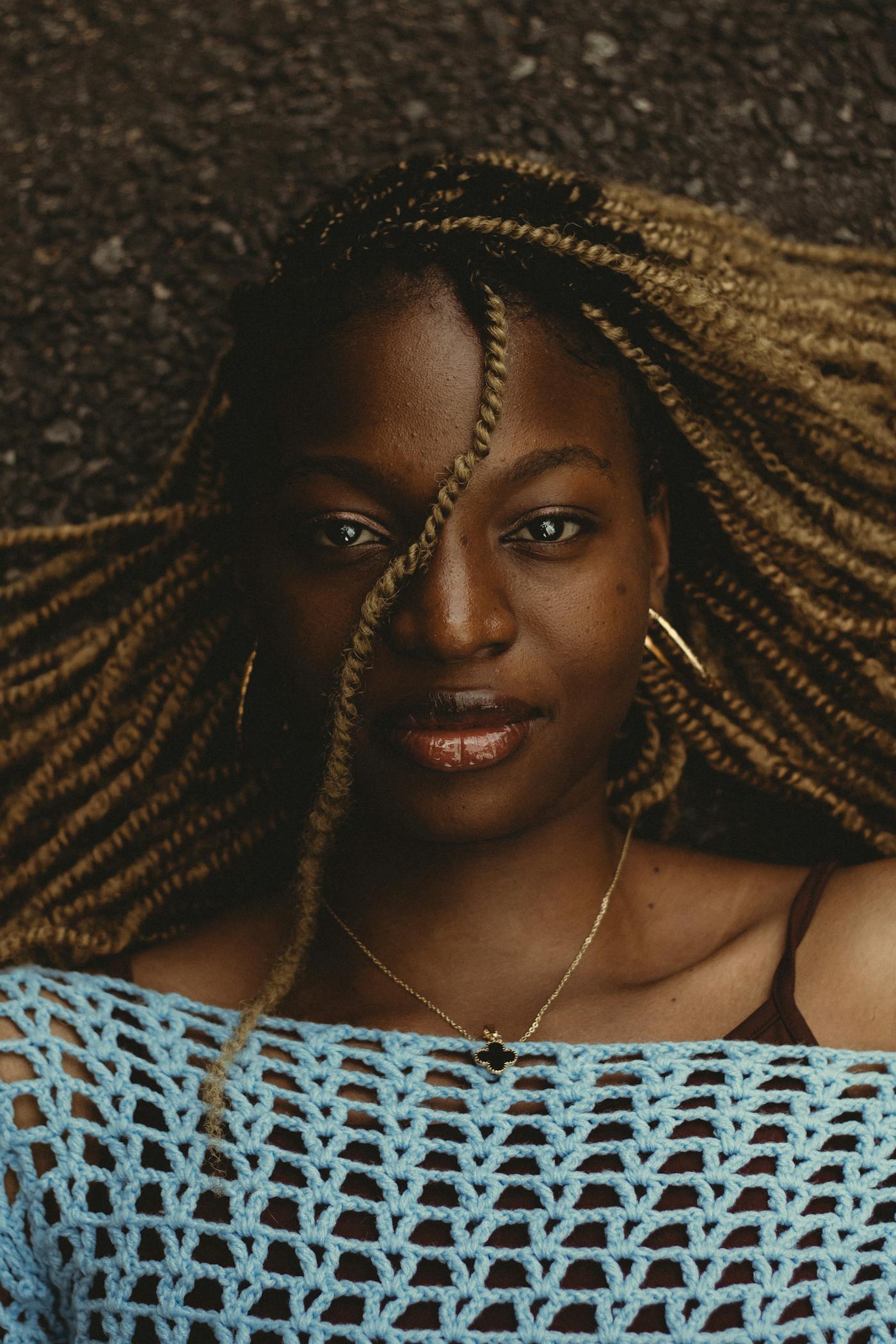 Honey-toned crochet braids framing the face