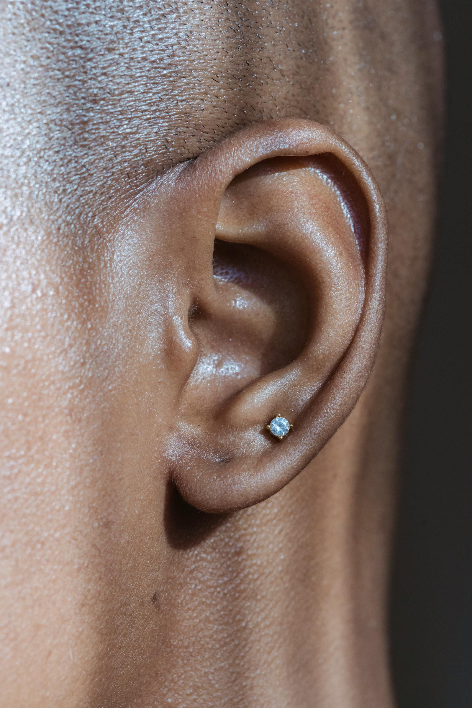 A clean single lobe piercing with a stud